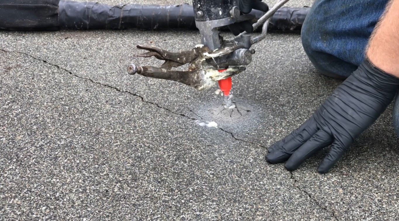 Technician injecting filler into concrete crack for repair in Laredo, TX