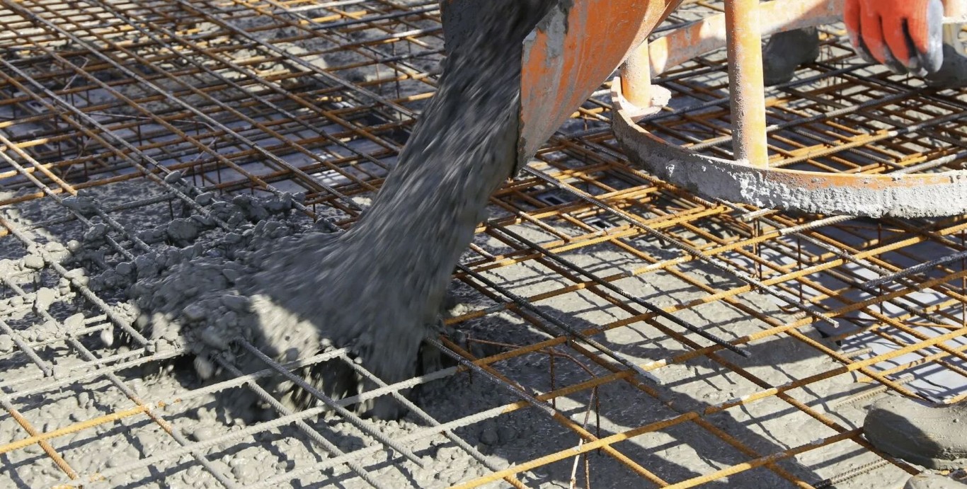 Concrete foundation slab being poured over rebar grid in Laredo, TX